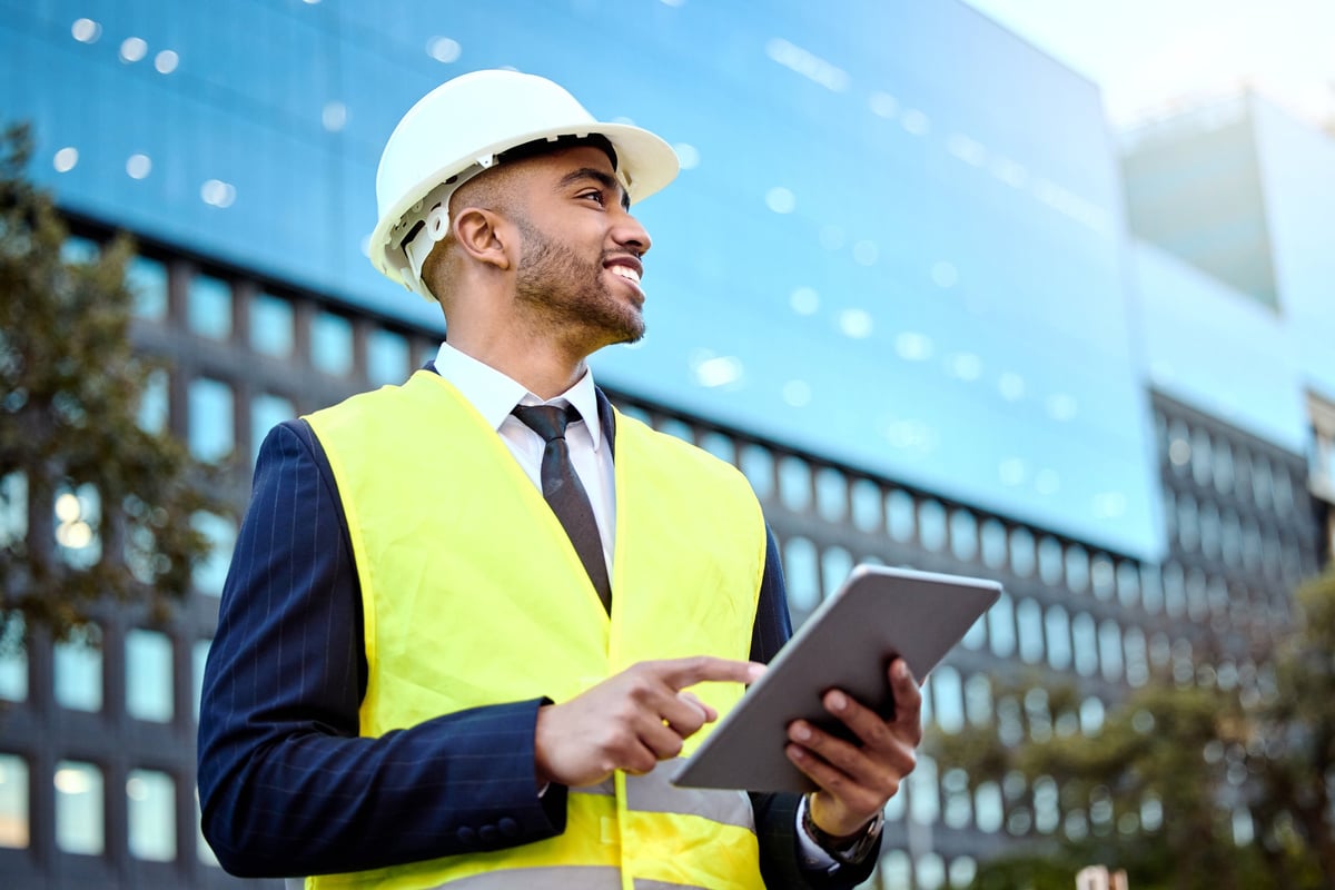 Construction professional reviewing project metrics and plans