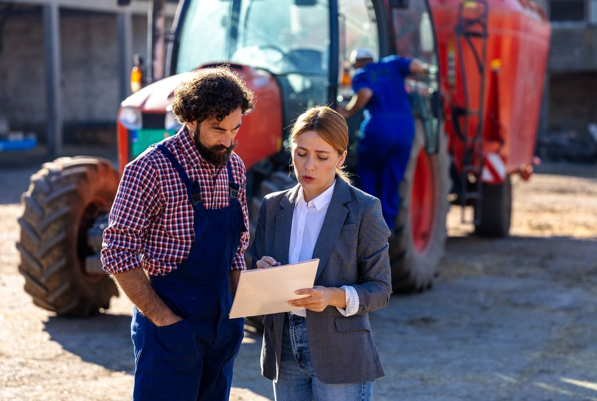 Farmer and business professional discussing farm operations